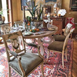 beauiful dining room table and chairs with rug and decorative items